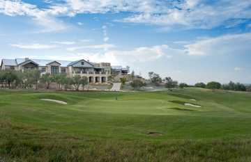 A view of the clubhouse with green in foreground at Cordillera Ranch Golf Course